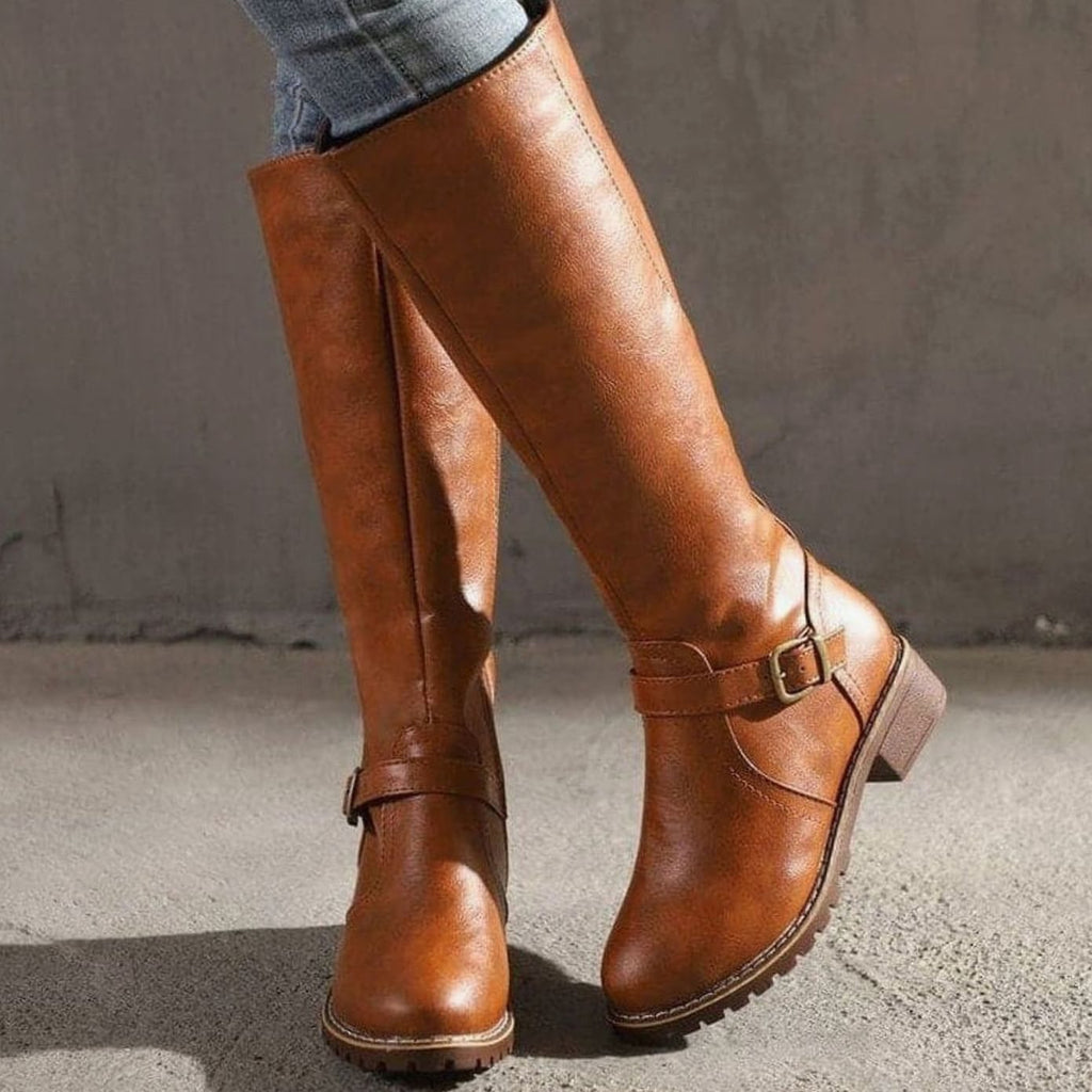 Faux leather knee high boots with buckle strap, front view