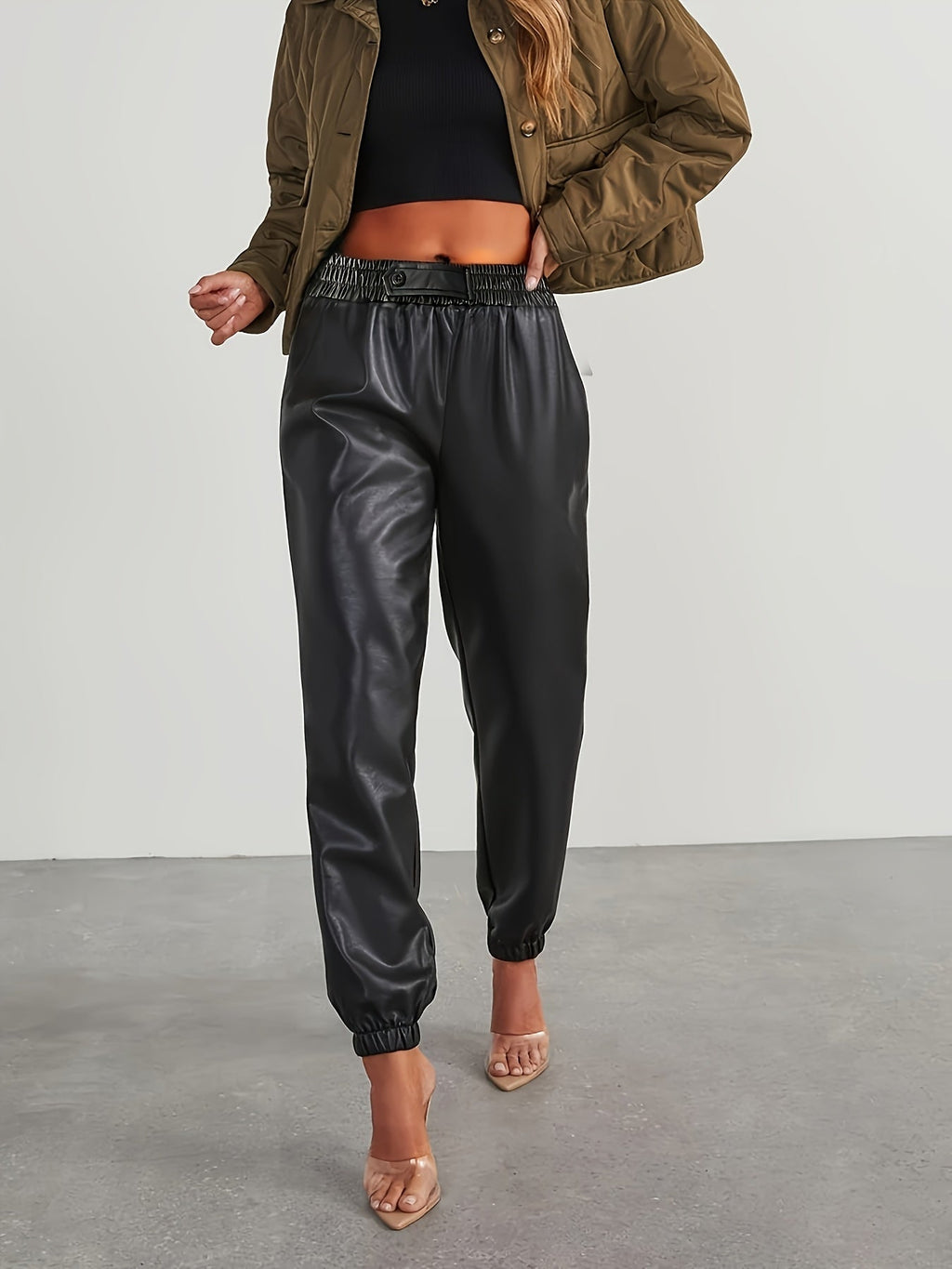Black tapered faux leather pants, front view