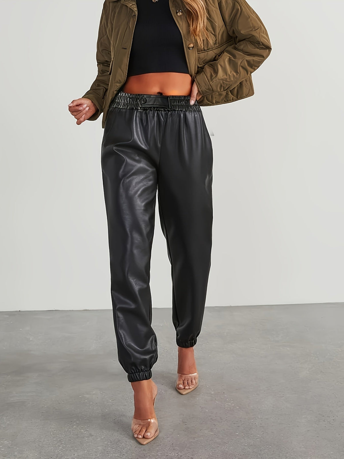 Black tapered faux leather pants, front view
